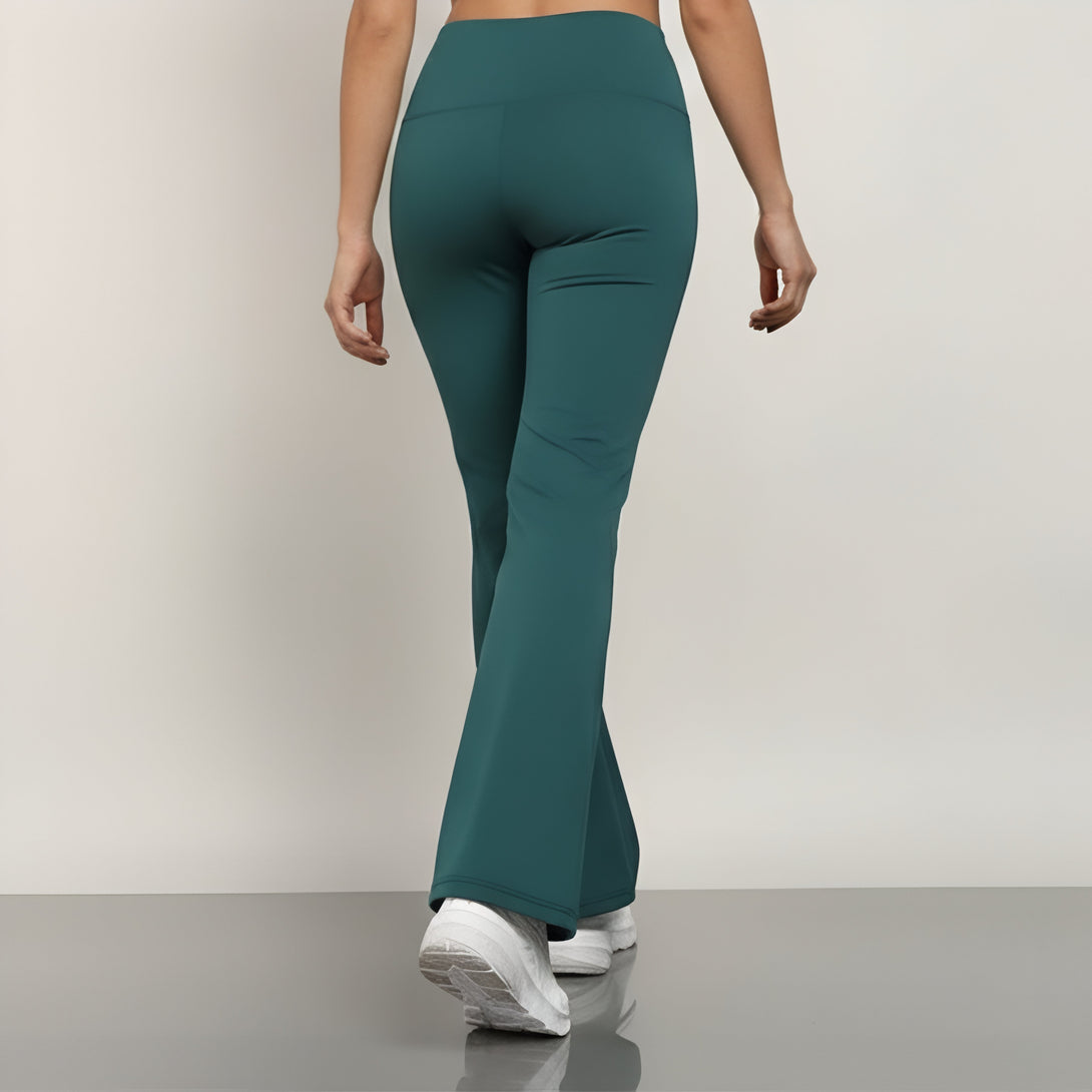Teal flared pants worn by a person on a plain background