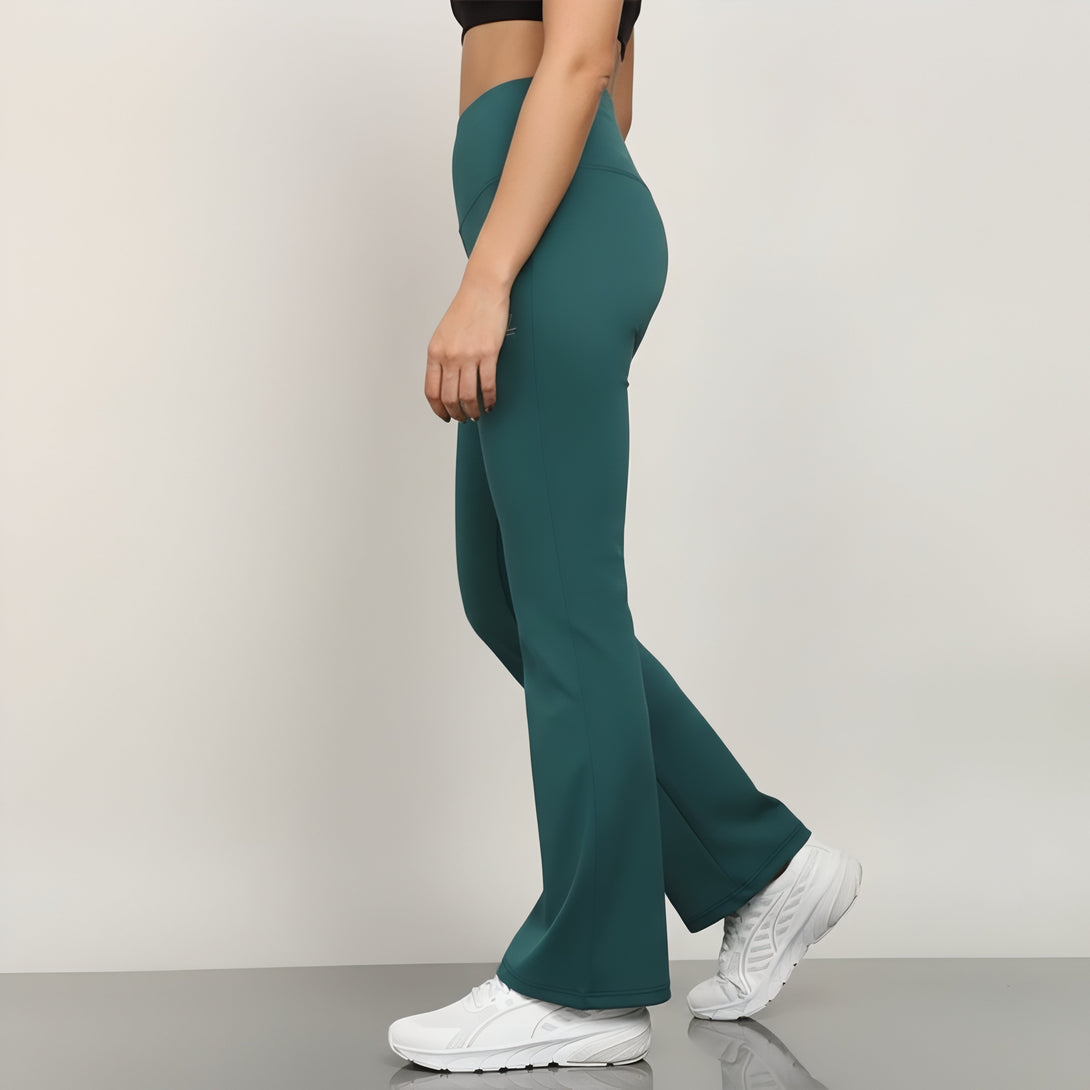 Teal flared pants worn by a person on a plain background