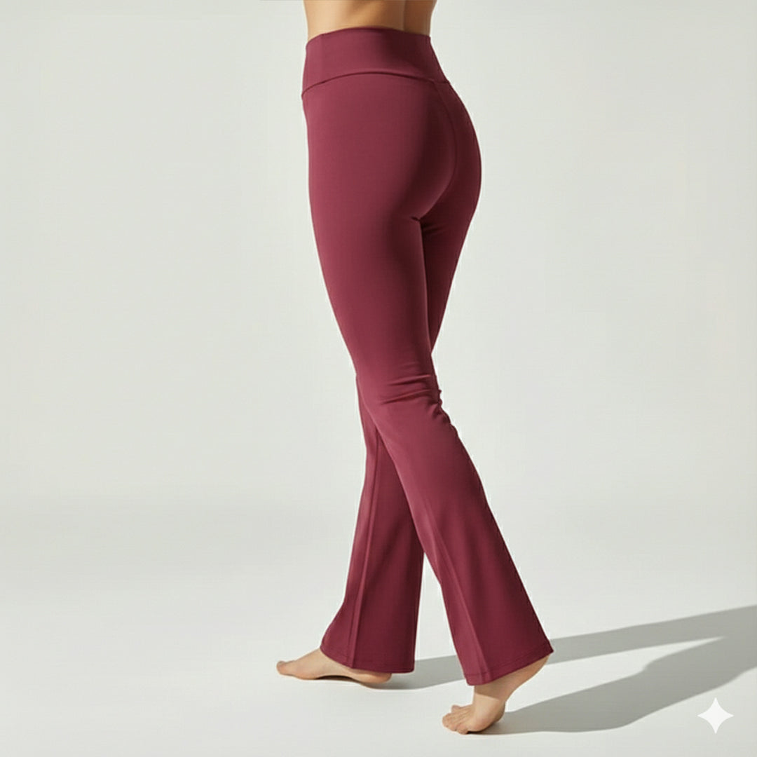 Maroon yoga pants worn by a person on a light gray background